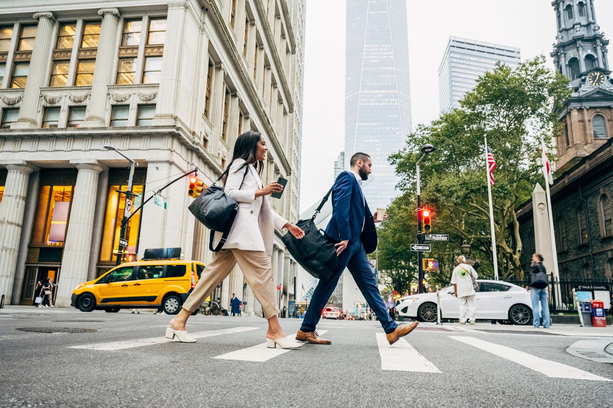 Business professionals crossing a city street