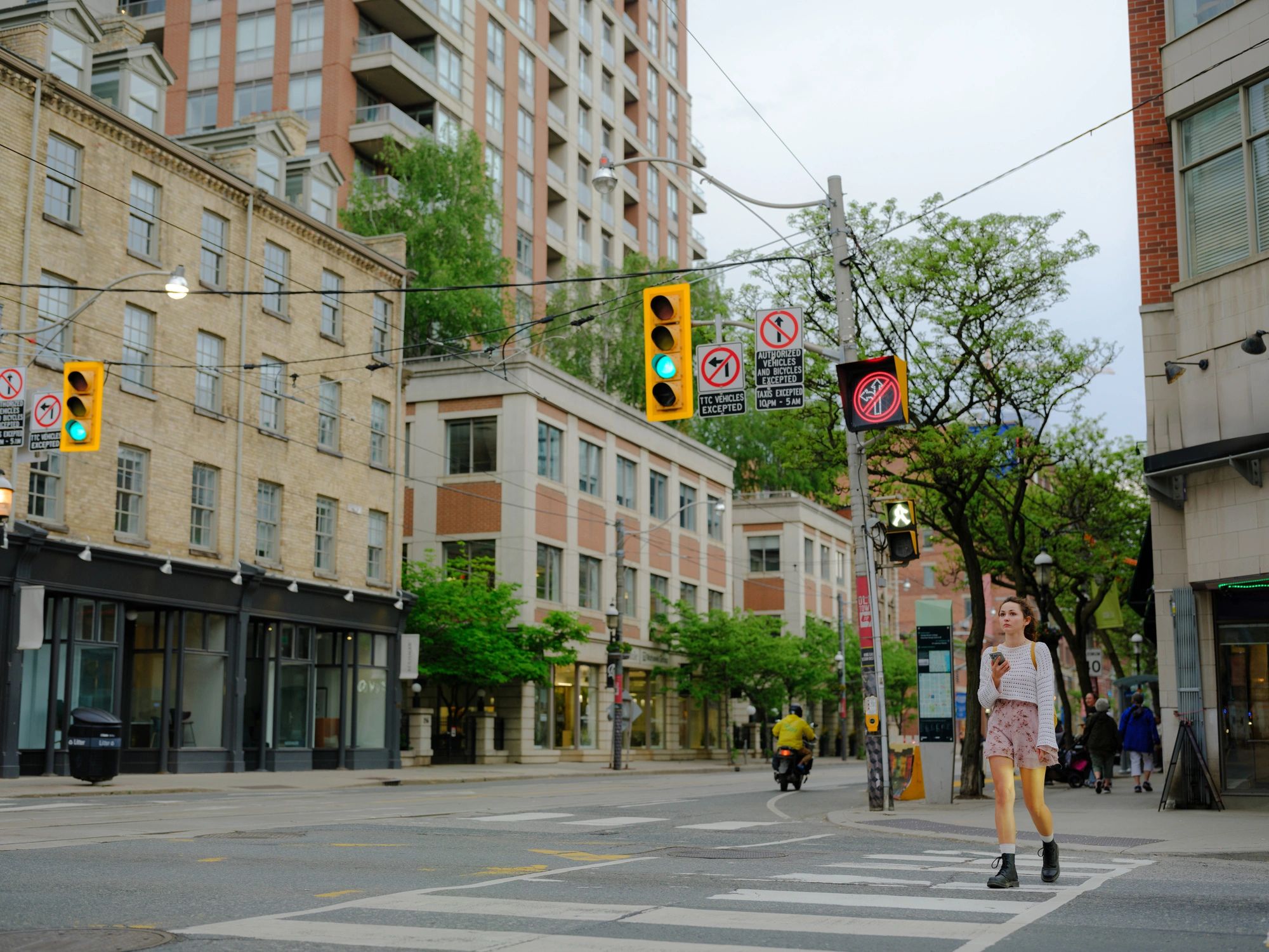 Woman using a smartphone on a crosswalk